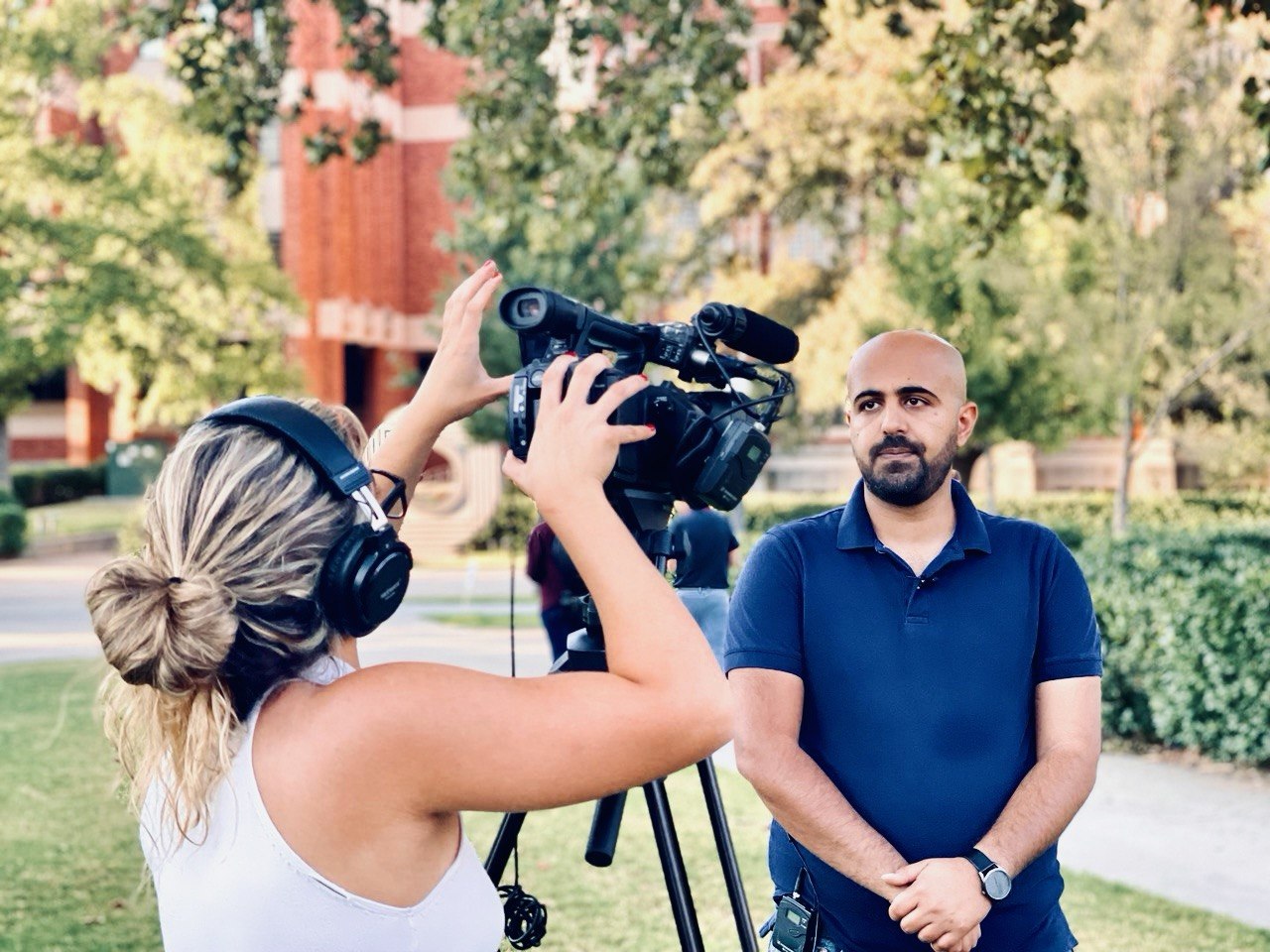 Peyman being interviewed by a television crew on the OU campus